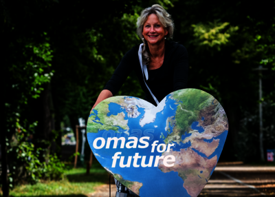 Autorin Cordula Weimann in der Natur mit einem Erdherz "Omas for future"